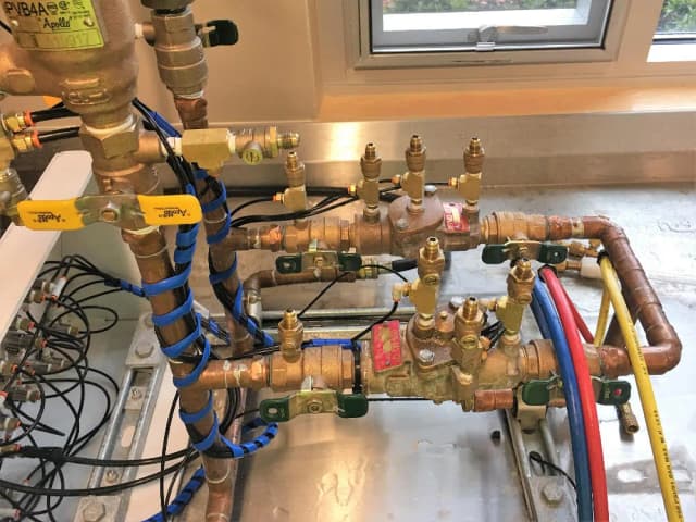 Professional tester inspecting a backflow device